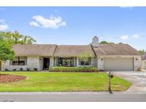 Charming single-story home features a well-manicured lawn and beautiful landscaping at 1558 Regal Oak Dr, Kissimmee, FL 34744