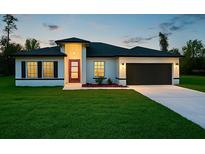 Charming single-story home with a well-manicured lawn, modern design, and inviting red front door at 2082 Sw 153Rd Loop, Ocala, FL 34473