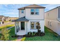 Charming two-story home with a welcoming porch and well-manicured landscaping at 4827 Lacewing Dr, Winter Garden, FL 34787