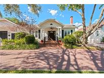 Charming home featuring a brick walkway, manicured landscaping, and inviting curb appeal at 525 Sheridan Blvd, Orlando, FL 32804