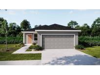 Charming single-story home with a two-car garage, manicured lawn, and inviting curb appeal at 5535 Maddie Dr, Haines City, FL 33844