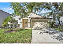 Charming single-story home featuring a well-manicured lawn and a two-car garage at 300 Augustine Ct, Oviedo, FL 32765