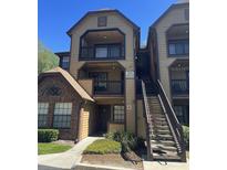 Condo building featuring a balcony and staircase leading to upper-level units at 315 Lakepointe Dr # 201, Altamonte Springs, FL 32701