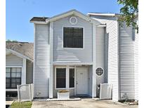 Inviting two-story home with a well-maintained yard and classic architectural details on a sunny day at 615 Clemson Dr, Altamonte Springs, FL 32714