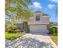 Charming two-story home with manicured lawn, mature tree, and two car garage at 1162 Lebanon Ct, Sanford, FL 32771