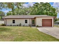 Charming single-story home featuring a well-maintained lawn and a one-car garage at 1179 Shadow Run Dr, Lakeland, FL 33813