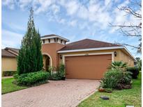 Charming single-story home with brick driveway and beautiful landscaping at 1390 Harbor Ridge Dr, Kissimmee, FL 34759