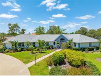 Beautiful home with well-manicured lawn, mature landscaping, and a welcoming entrance at 203 Prestwick Dr, New Smyrna Beach, FL 32168