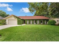 Charming single-story home with a well-manicured lawn and unique ivy-covered facade at 222 Yarmouth Rd, Fern Park, FL 32730