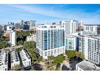 Stunning aerial view of a modern high-rise building in a bustling city with blue skies and mature landscaping at 260 Osceola Ave # 902, Orlando, FL 32801