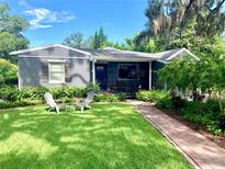 Charming single-story home with a well-manicured lawn, beautiful landscaping and cozy sitting area at 750 Hempstead Ave, Orlando, FL 32803