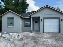 Charming single-story home featuring a gray exterior with a one-car garage and a well-maintained front yard at 2451 W 18Th St, Sanford, FL 32771