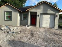 Charming home featuring a red front door and a single car garage at 2451 W 18Th St, Sanford, FL 32771