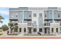 Modern townhome exteriors featuring stone accents, balconies, and well-maintained landscaping create inviting curb appeal at 336 Center Lake Ln # A-2, Oviedo, FL 32765