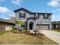 Charming two-story home with landscaped yard and attached two-car garage at 4346 Trotters Way, Lakeland, FL 33801