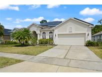 Charming single-story home features a well-manicured lawn, solar panels and a two-car garage at 625 Waterland Ct, Orlando, FL 32828