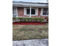 Charming brick home featuring well-maintained landscaping and large windows at 769 Avenue Q Se, Winter Haven, FL 33880