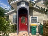 Charming home exterior with a red front door and brick-paved entrance, creating an inviting curb appeal at 250 E 20Th Ave, Mount Dora, FL 32757