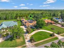 Expansive aerial view of a home with a circular driveway, solar panels and lush green landscaping at 14343 Tilden Rd, Winter Garden, FL 34787