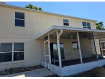 Enclosed patio with ceiling fans provides outdoor living space off of the main house at 2018 Knollcrest Dr, Clermont, FL 34711