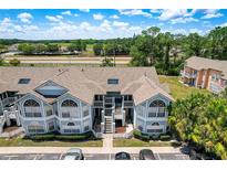 Inviting light blue condominium complex with arched windows and well-maintained landscaping at 2028 Royal Bay Blvd # 85, Kissimmee, FL 34746