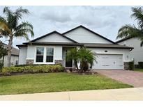 Charming single-Gathering home featuring mature landscaping and a two-car garage at 2445 Verde View Dr, Apopka, FL 32703