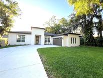 Contemporary home boasting a well-manicured lawn and an extra long driveway at 3764 Rachel St, Apopka, FL 32703