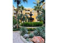 Picturesque courtyard showcasing a central fountain, lush greenery, and palm trees surrounding the charming building at 860 N Orange Ave # 460, Orlando, FL 32801