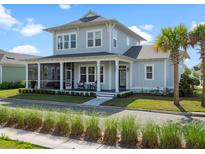 Charming two-story home featuring a screened porch, a welcoming front porch, and well-manicured landscaping at 921 Bradenville Ln, Winter Garden, FL 34787