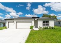 Charming single-story home featuring a three-car garage and well-maintained lawn at 12950 Sw 38Th Cir, Ocala, FL 34473