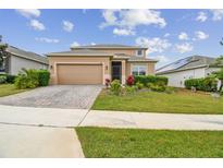 Beautiful two-story home featuring a two-car garage, manicured lawn, and stone accents at 1028 Sadie Ridge Rd, Clermont, FL 34715