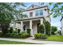 Charming two-story home with landscaped yard, front porch, and inviting curb appeal at 1052 Avila Ln, Orlando, FL 32803