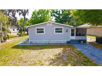 Charming single story home featuring a well-maintained front yard and a white picket fence at 111 Palencia Rd, Auburndale, FL 33823
