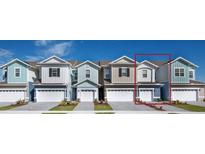 Charming townhome boasts a modern design, neutral siding, and a one-car garage at 1353 Stockwell Ave, St Cloud, FL 34771