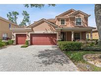Charming two-story home with three-car garage, lush landscaping, and paver driveway offers curb appeal at 442 Anessa Rose Loop, Ocoee, FL 34761