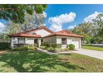 Charming single Gathering home featuring a well-manicured lawn and mature trees at 7423 Elsworth Ct, Orlando, FL 32819