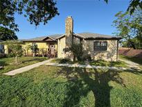 Charming single-Gathering home with a stone exterior and a lovely stone chimney at 1221 Perkins Rd, Orlando, FL 32809