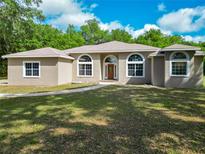 Charming single-story home with well-maintained lawn and a welcoming entrance at 1406 Cr 542G, Bushnell, FL 33513