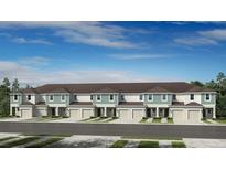 New townhome development with multi-car garages, sidewalk and neutral color scheme on a partly cloudy day at 180 River Front Way, Edgewater, FL 32141