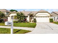 Charming home featuring a well-manicured lawn, inviting entrance, and a two-car garage at 3617 Cherry Hill Dr, Orlando, FL 32822