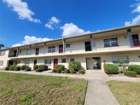 Exterior view of a multi-Gathering complex with well-maintained landscaping and a bright blue sky at 5505 Hernandes Dr # 118, Orlando, FL 32808