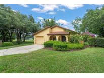 Charming yellow home with well-manicured lawn and landscaping at 6301 Parson Brown Dr, Orlando, FL 32819