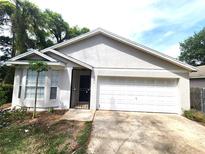 Close-up of a charming single-story home showcasing its well-kept exterior and inviting entrance, complete with a security gate at 101 Dovetail Ct, Apopka, FL 32703