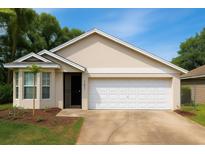 Charming one-story home featuring a neutral stucco finish, well-kept lawn, and attached two car garage at 101 Dovetail Ct, Apopka, FL 32703