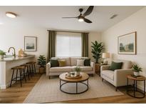 Bright living room featuring modern furnishings, a ceiling fan, and neutral decor at 101 Dovetail Ct, Apopka, FL 32703