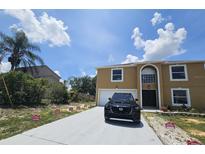 Two-story home featuring an attached garage, well-maintained lawn, and 'Open House' signs on the driveway at 2004 Prescott Blvd, Deltona, FL 32738