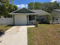 Charming single-story home featuring a well-maintained lawn, attached garage, and welcoming front entrance at 209 Silas Phelps W Ct, Orlando, FL 32828