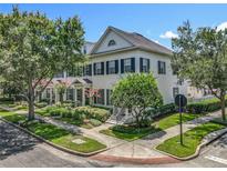 Charming two-story home with manicured landscaping, lush trees, and classic architectural details at 2240 Osprey Ave, Orlando, FL 32814