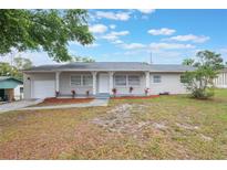 Charming single-story home with a well-maintained lawn and inviting front porch at 2113 Winnetka Ct, Orlando, FL 32818