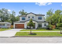 Beautiful two-story home with modern wood garage door and manicured front yard at 2306 Hargill Dr, Orlando, FL 32806